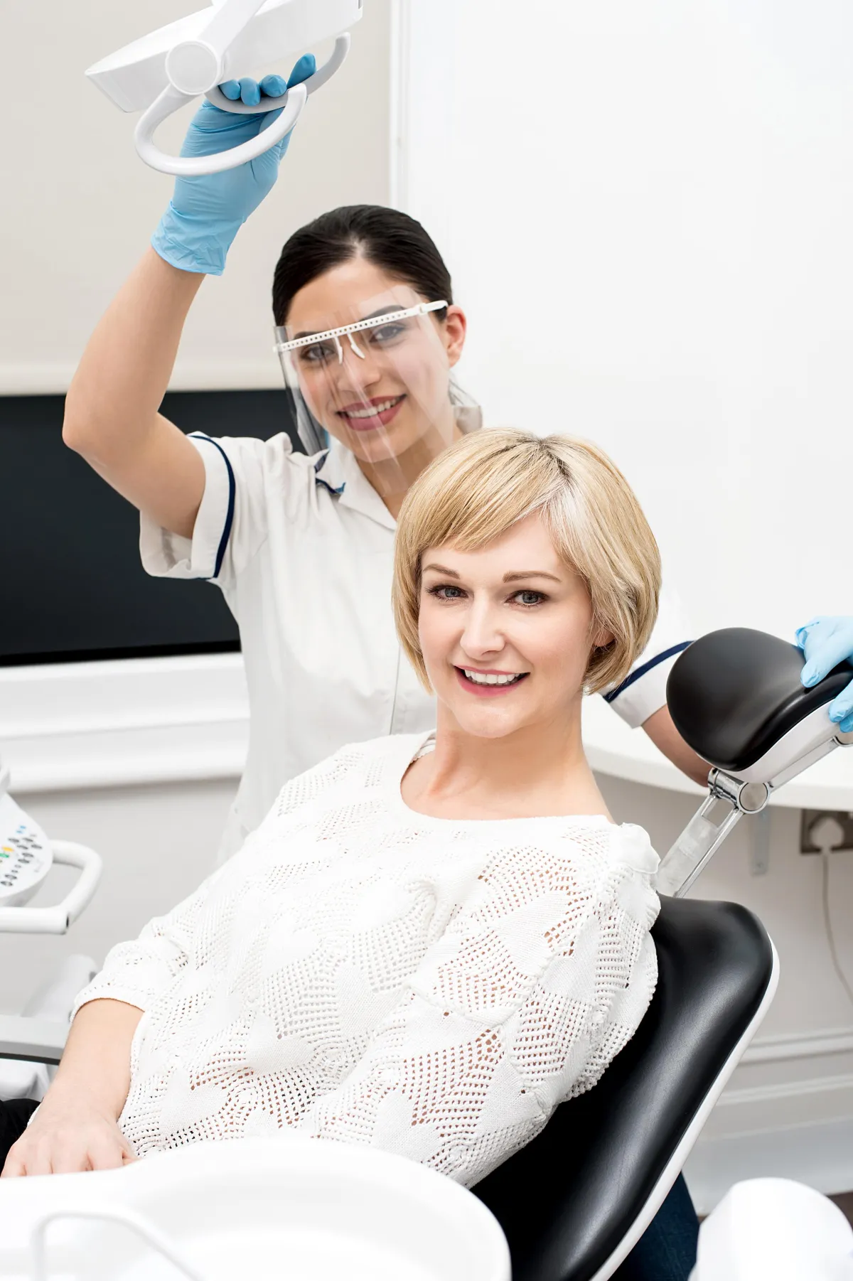 a dentist holding a dental tool over a person's mouth