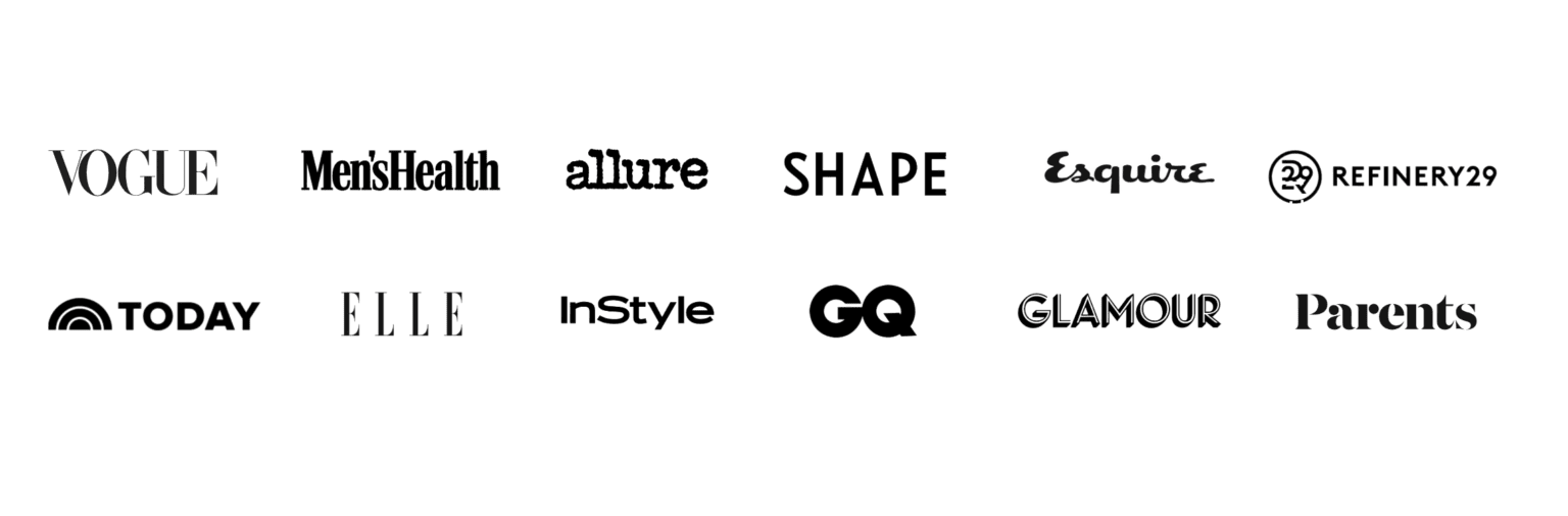 A professional woman seated on a sofa with a laptop, in a modern and minimalistic setting,