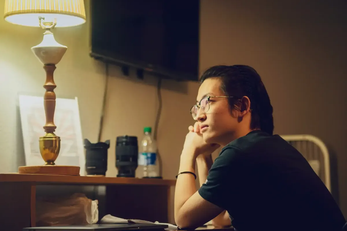 Professional sitting alone at night, thinking back over a conversation from earlier in the day