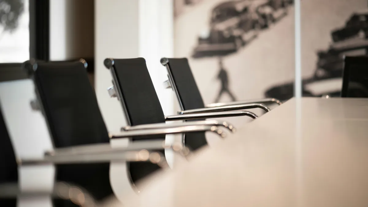 A set of empty chairs in a meeting room