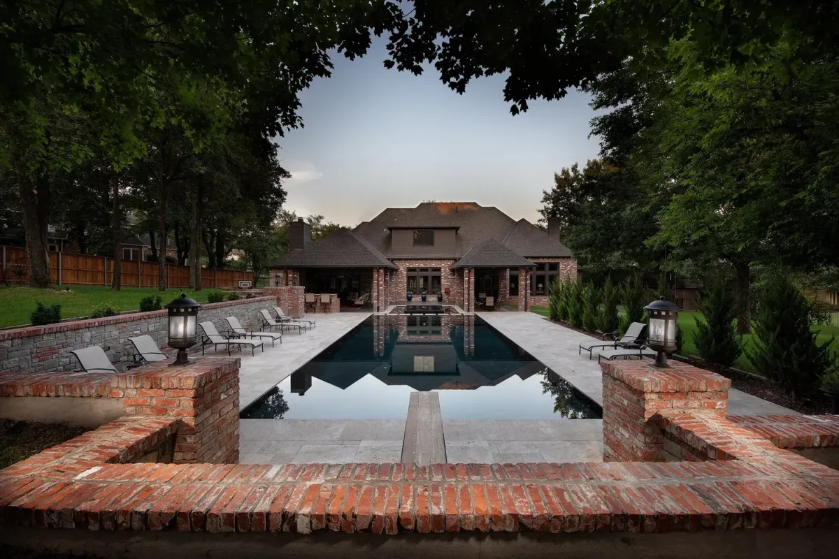 a small pool with lounge chairs next to it