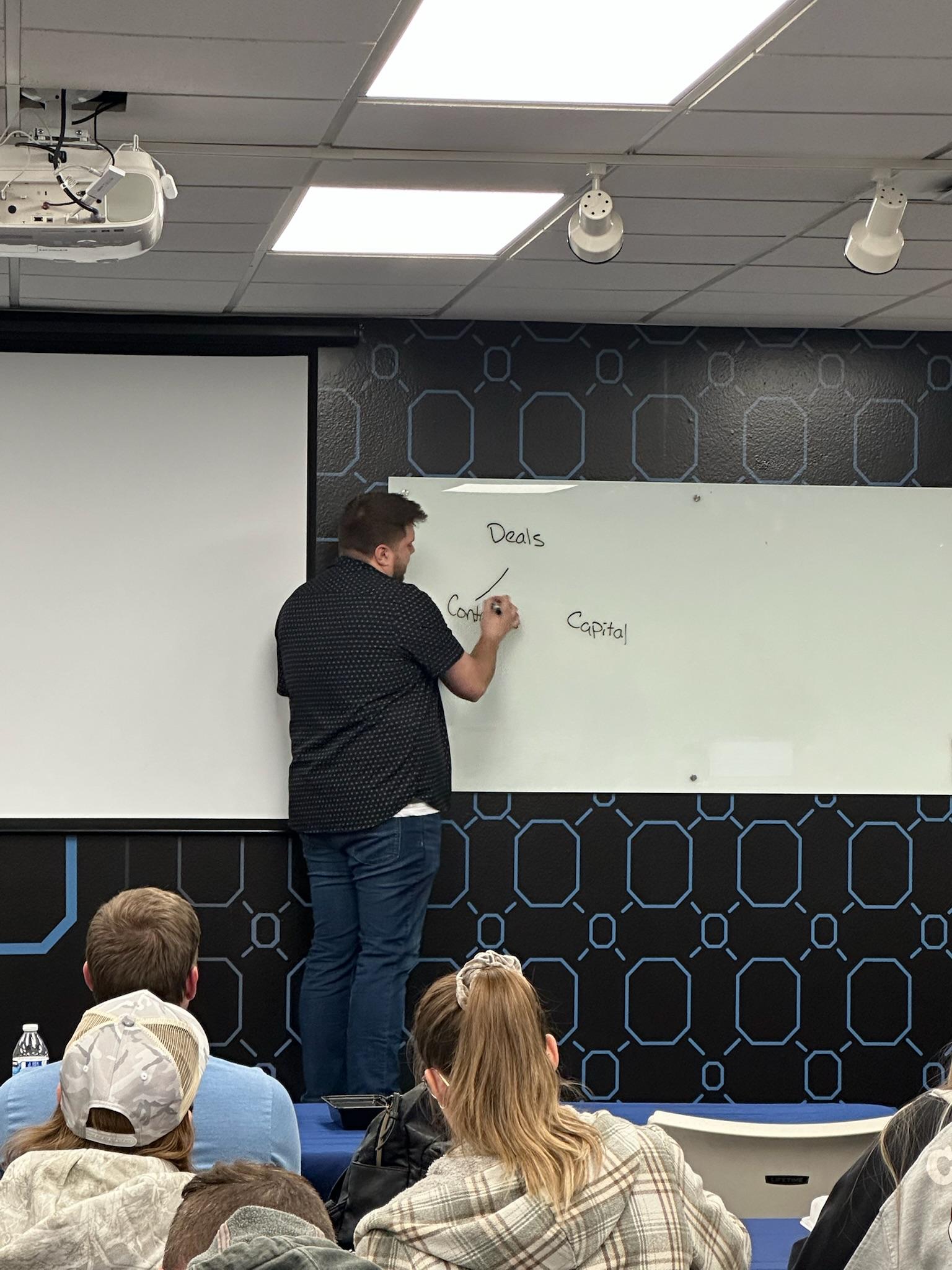 grayscale photo of man walking on road