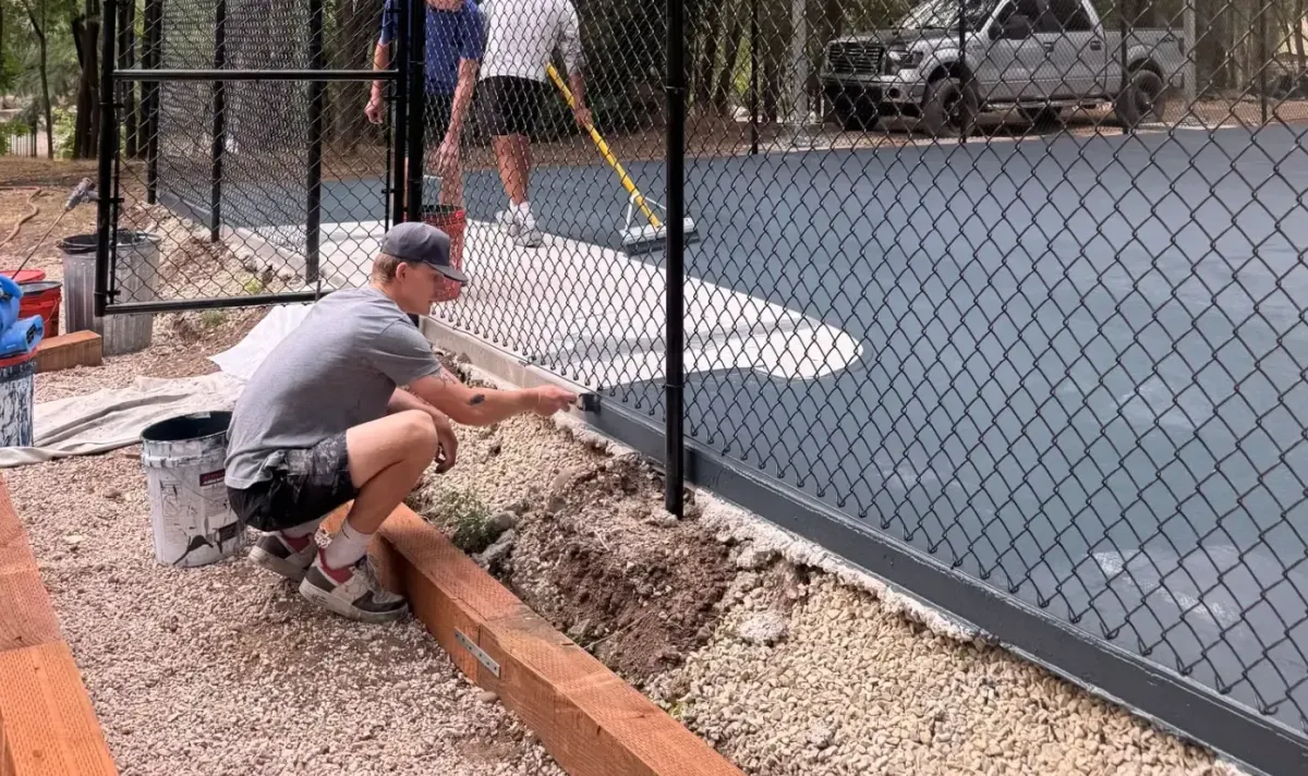 ace coatings crew performing resurfacing of a court