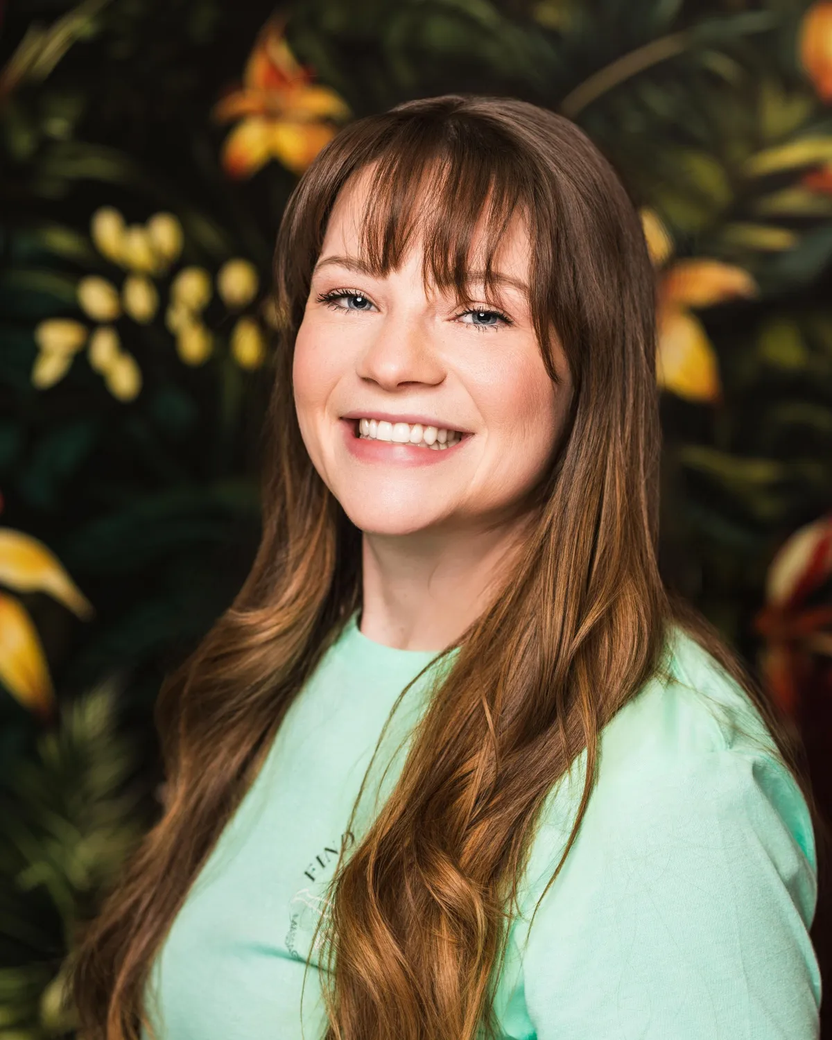 person on brown hammock with steel base across body of water