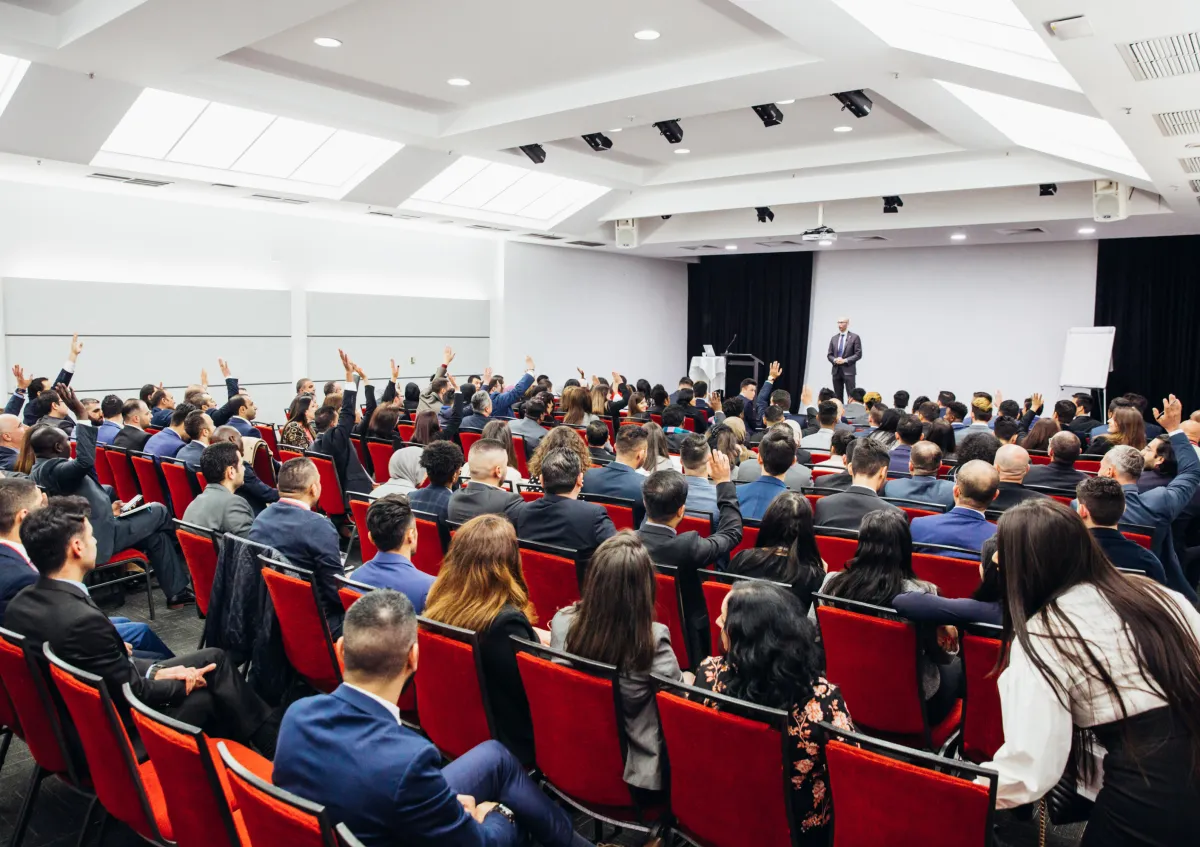 A large group of CareerSeekers seated in an auditorium for Leadership Development Institute (LDI), viewed from behind, facing a stage