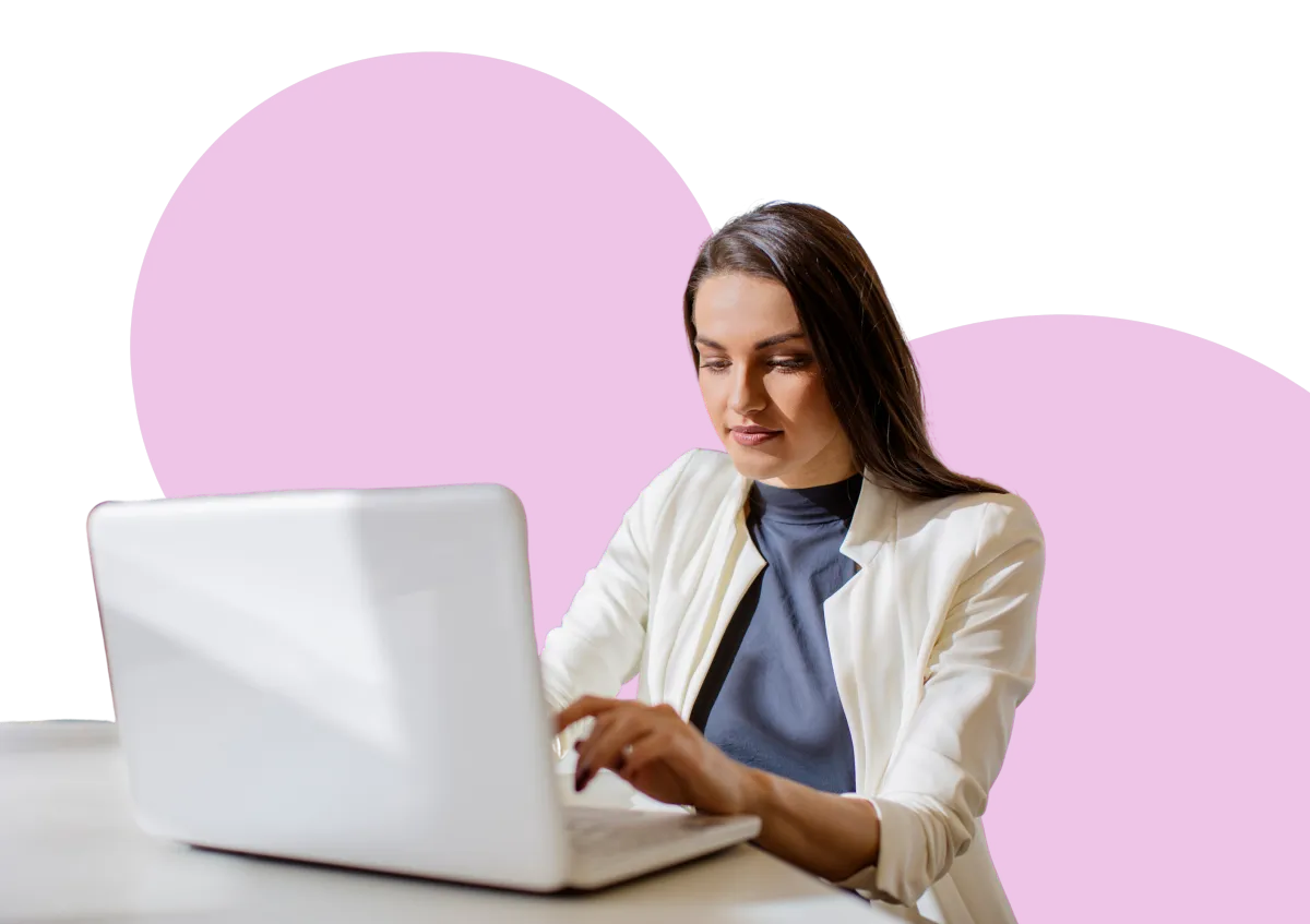 A woman working on a laptop at a desk, representing the first step of identifying a hosting opportunity.
