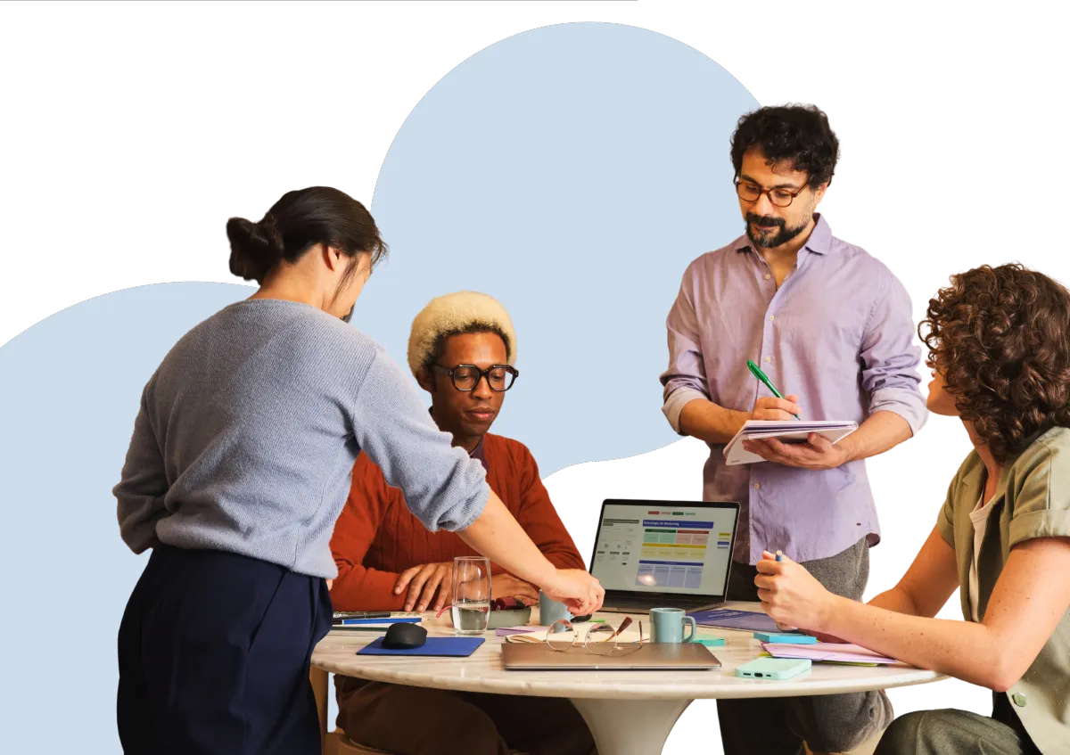 A small team collaborating around a table during a workplace placement