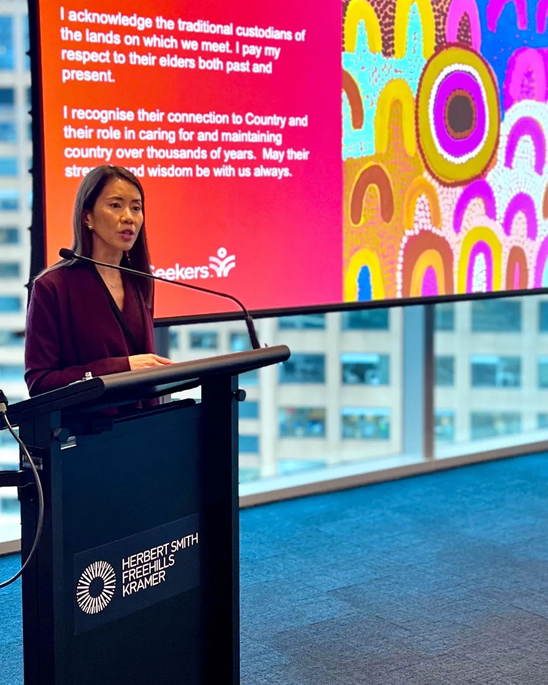 A HSFK leader speaking at a podium at a CareerSeekers event
