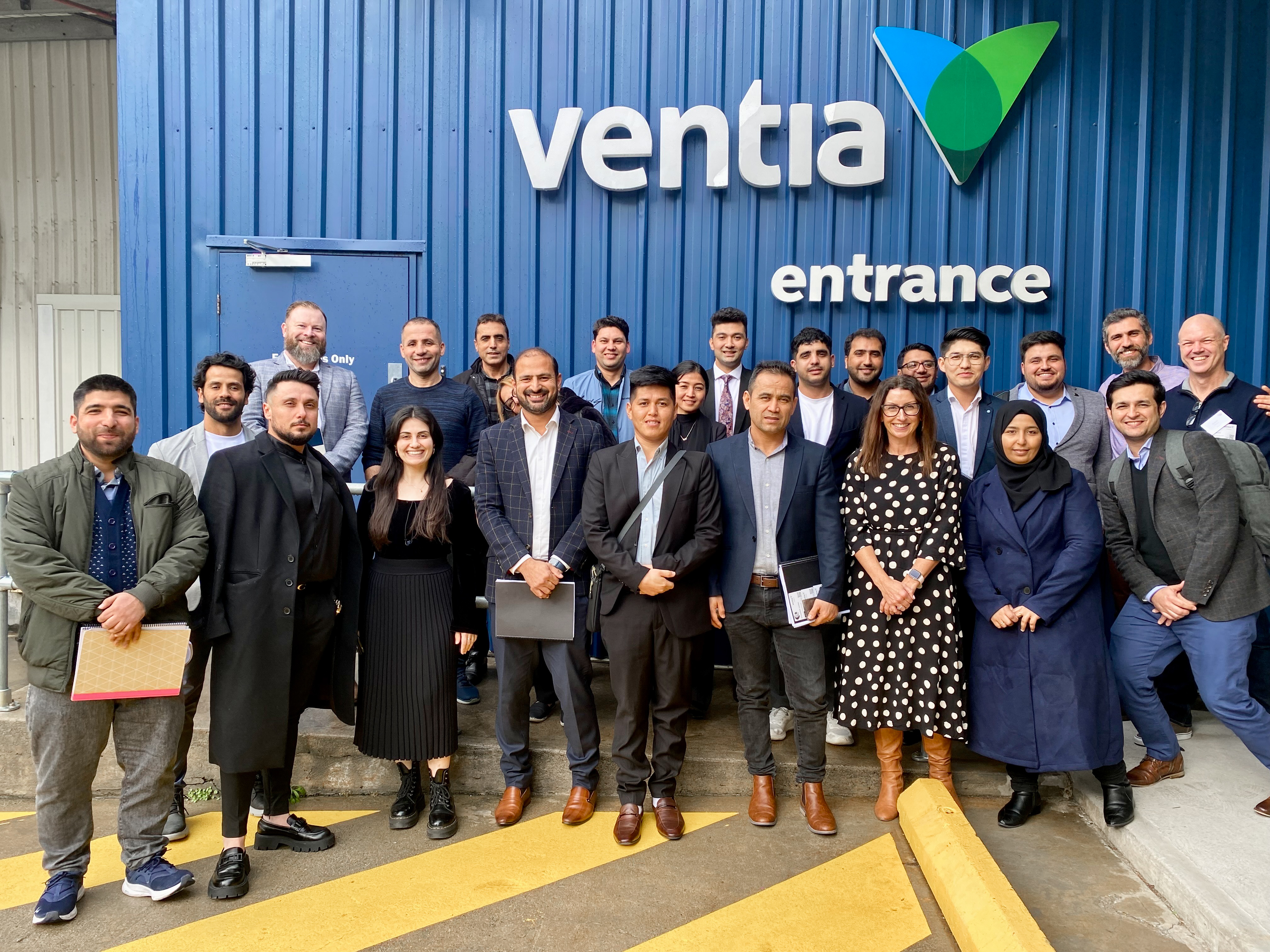 A large group of Ventia team members and CareerSeekers' participants and team posing together in front of the Ventia office