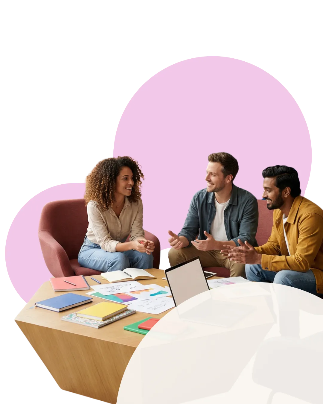 Three colleagues in conversation around a low coffee table while working