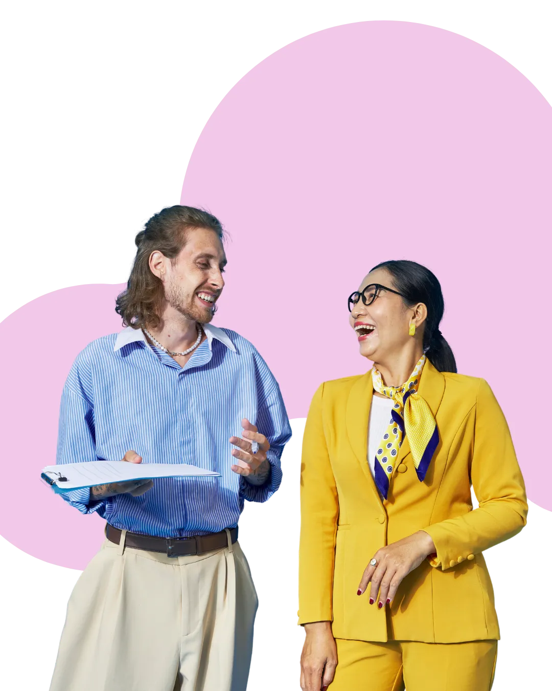 Two professionals in business attire chatting together, one holding papers, the other gesturing mid-conversation