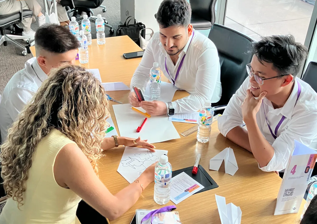 A small group of CareerSeekers participants working together at a table during a workshop activity