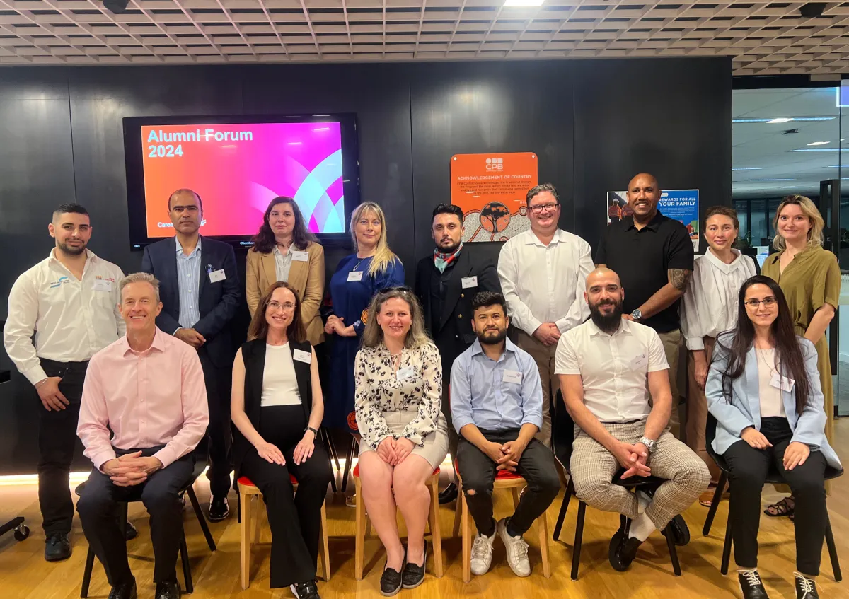 A large group of CareerSeekers' alumni seated together and posing for a group photo