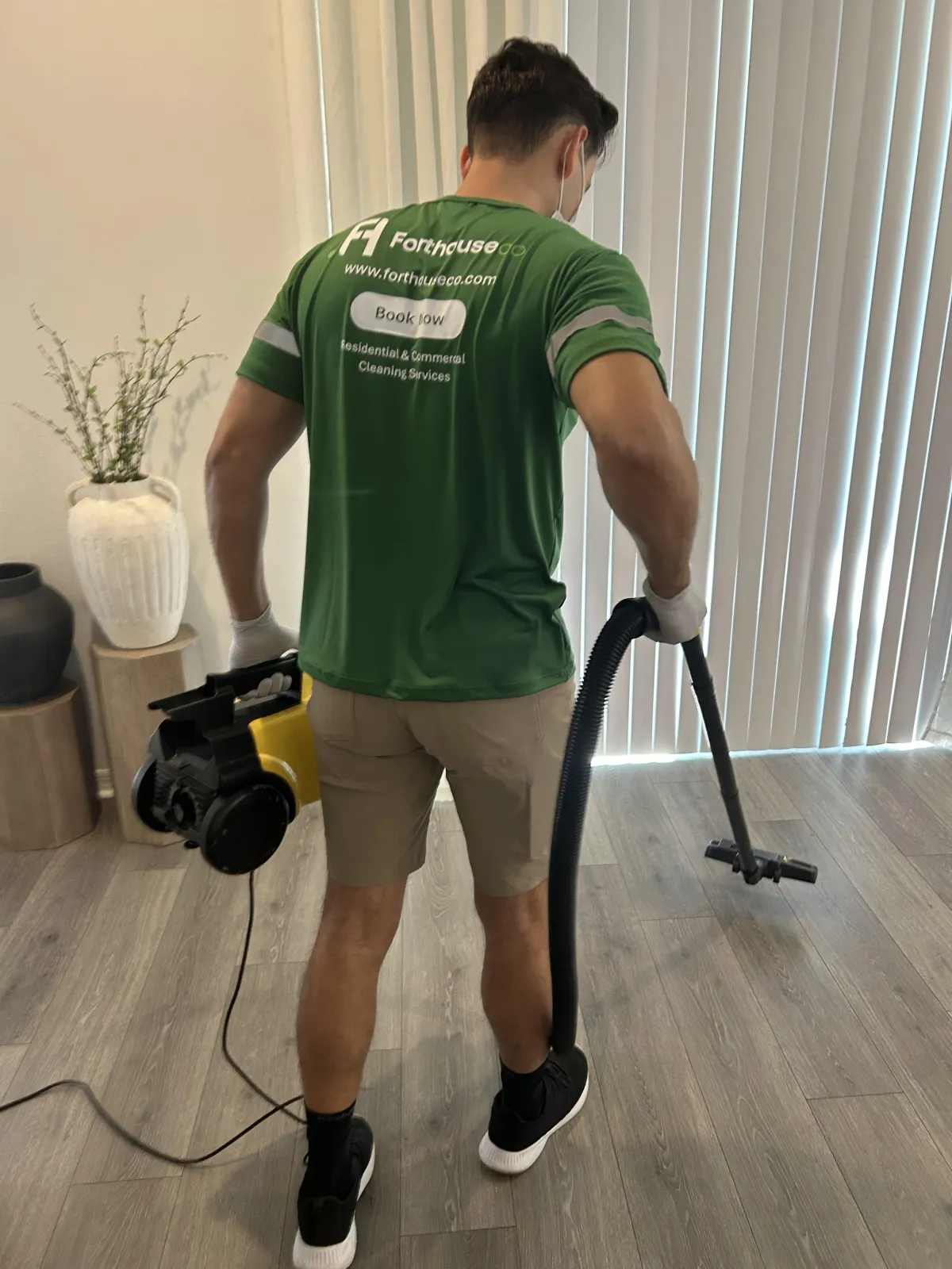 Adding cleaning powder to a mop bucket.