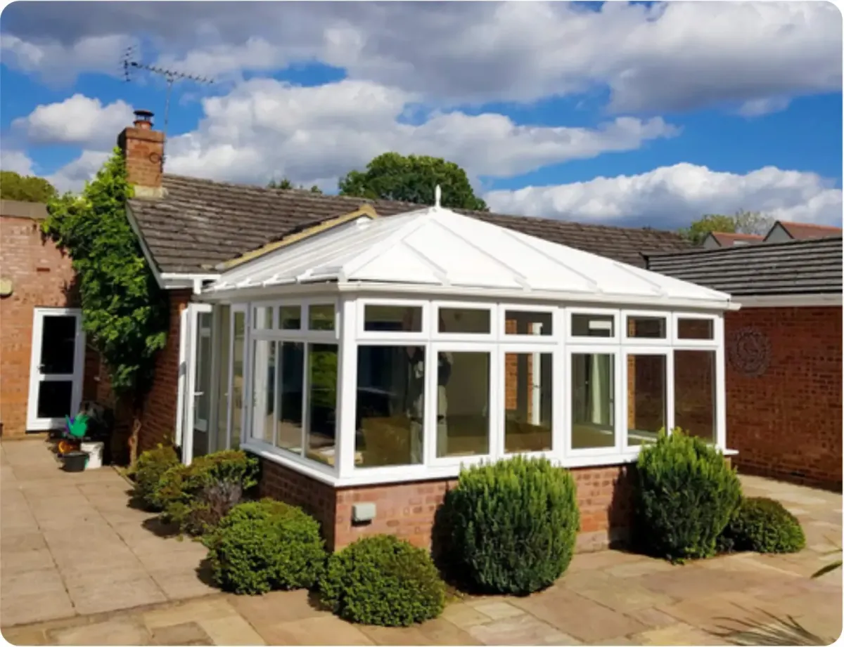 A stunning white PVC conservatory with a new white replacement roof