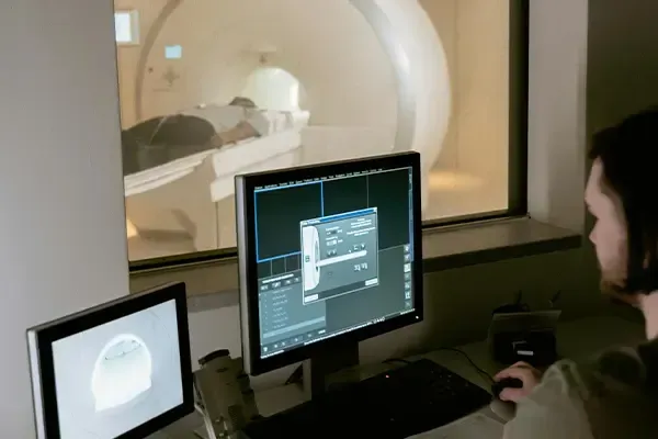 technician performing a CT scan