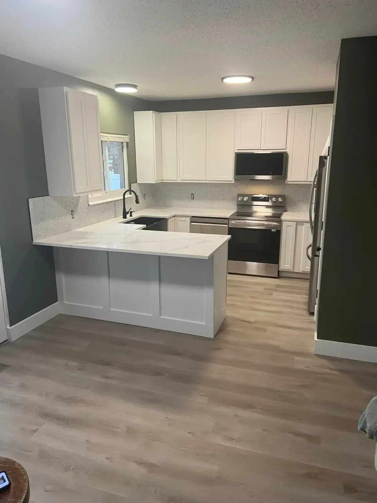 Modern kitchen remodel in St. Charles, MO with updated cabinets, flooring, and open layout.
