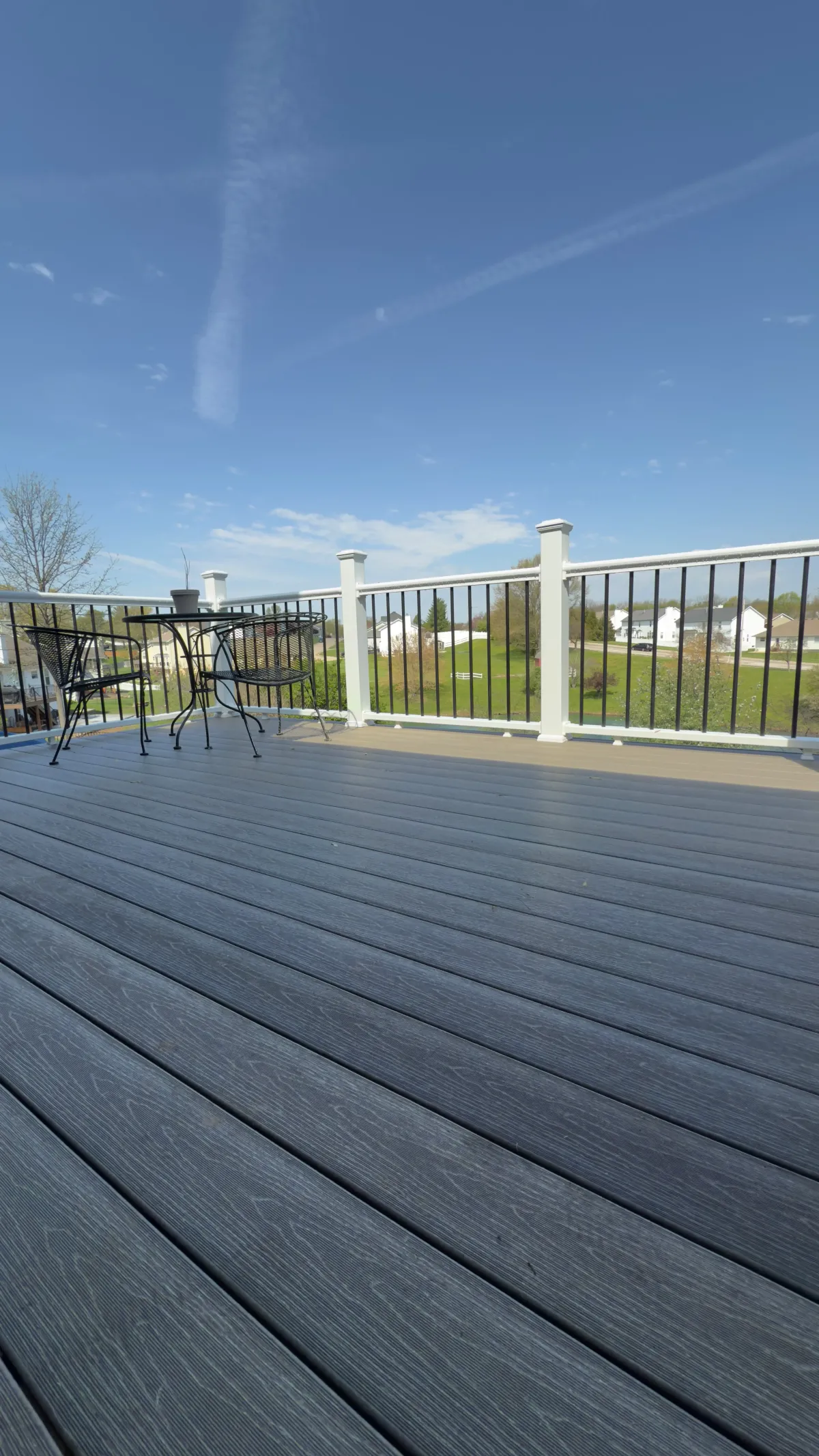 Family enjoying dinner on a cozy backyard deck in O’Fallon, MO – outdoor living upgrade at sunset.