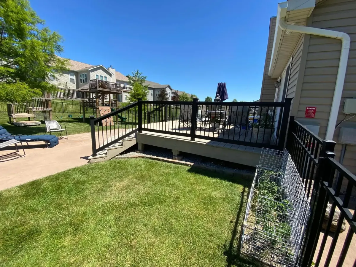 Black metal deck railing with newel posts installed in Dardenne Prairie, MO – modern safety feature for raised decks.