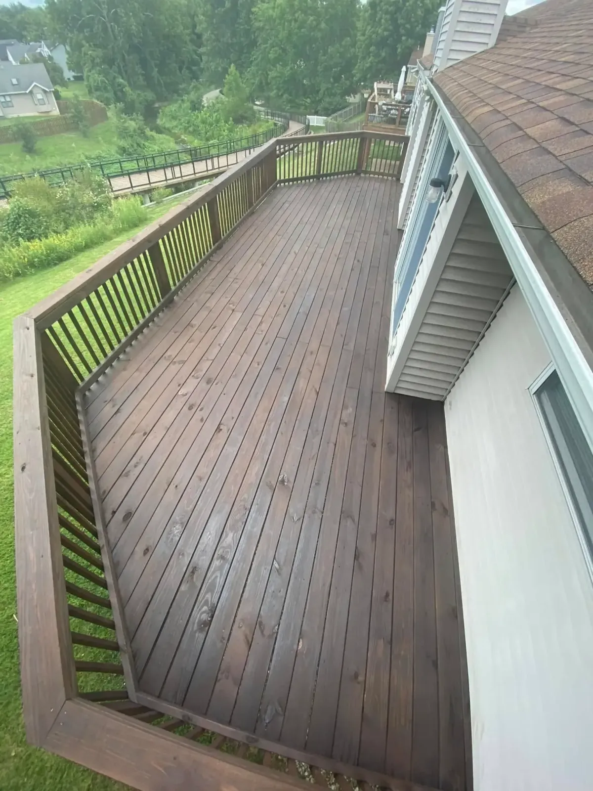 Custom hexagonal deck design in Dardenne Prairie, MO – stained wood finish with perimeter railing.