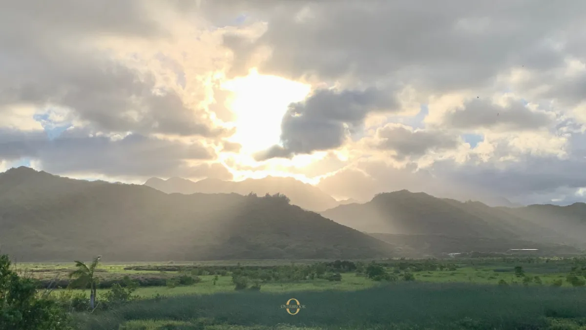 Sunlight illuminating a Hawaiian ridgeline and valley landscape, representing visibility and legibility in the Ridgeline leadership series.