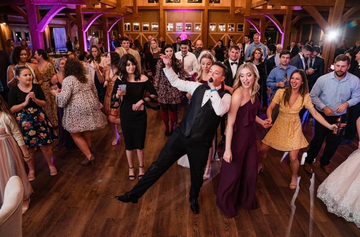 Springfield, MO wedding DJ leading guests on packed dance floor at reception