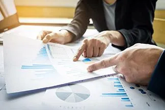 Business people evaluating charts and graphs