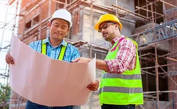 Contractors looking at construction plans