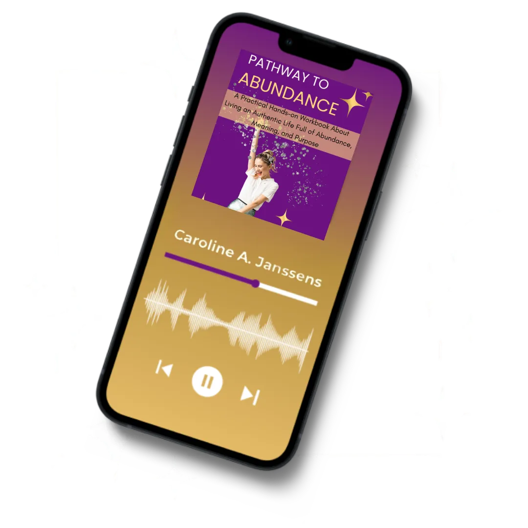 Pathway to Abundance" audiobook by Caroline A. Janssens displayed on a smartphone, supporting abundance mindset coaching, self-improvement, and personal growth through audio learning.