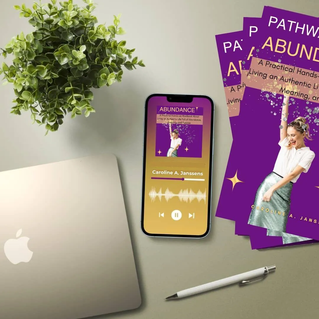 Pathway to Abundance" audiobook by Caroline A. Janssens displayed on a smartphone, supporting abundance mindset coaching, self-improvement, and personal growth through audio learning.