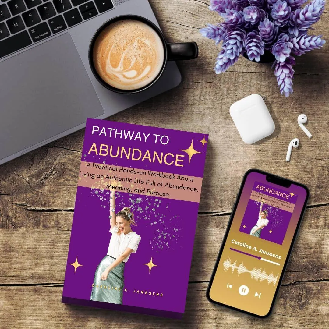 Pathway to Abundance" audiobook by Caroline A. Janssens displayed on a smartphone, supporting abundance mindset coaching, self-improvement, and personal growth through audio learning.