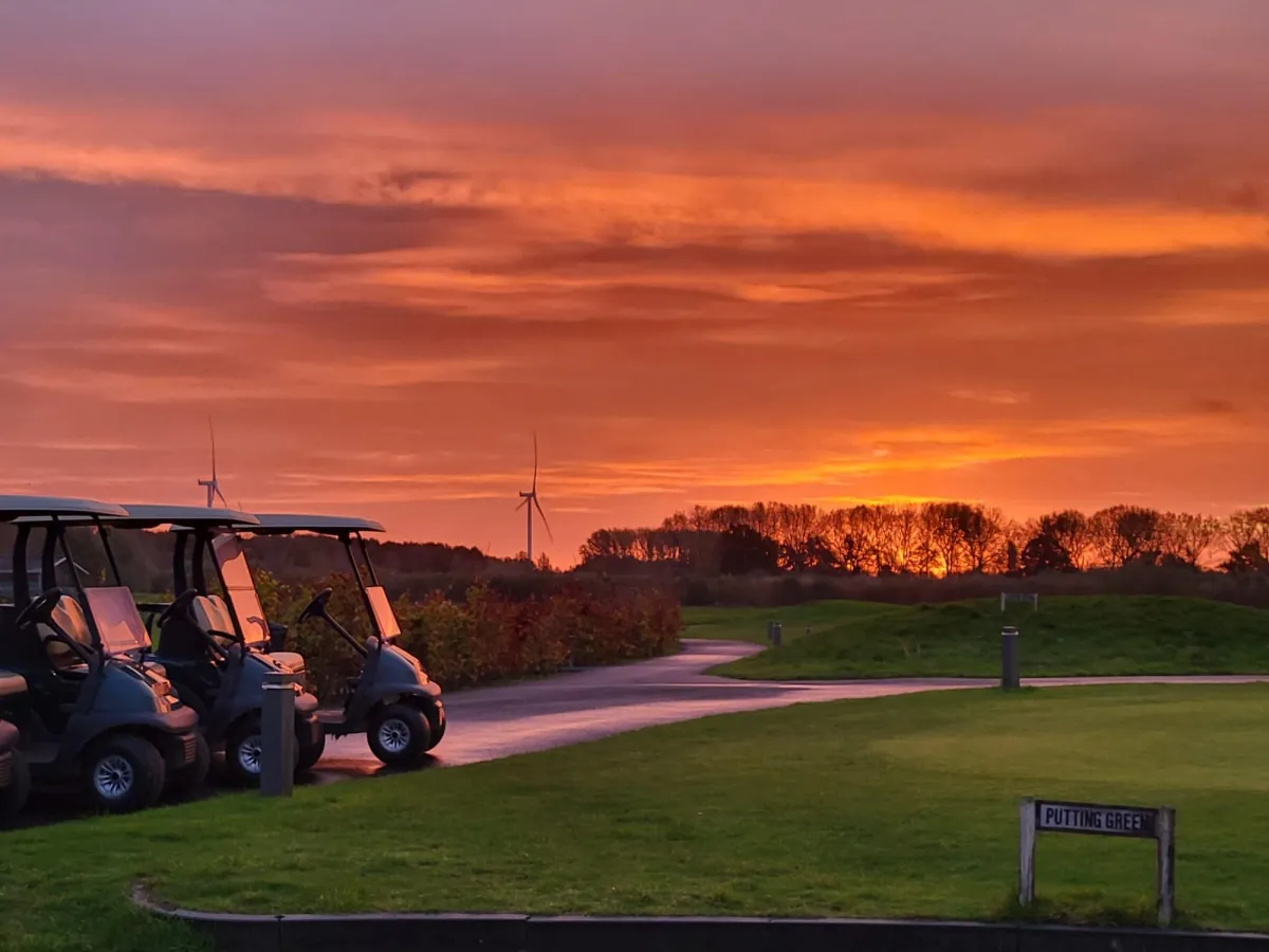 man in black shirt and black pants playing golf during daytime