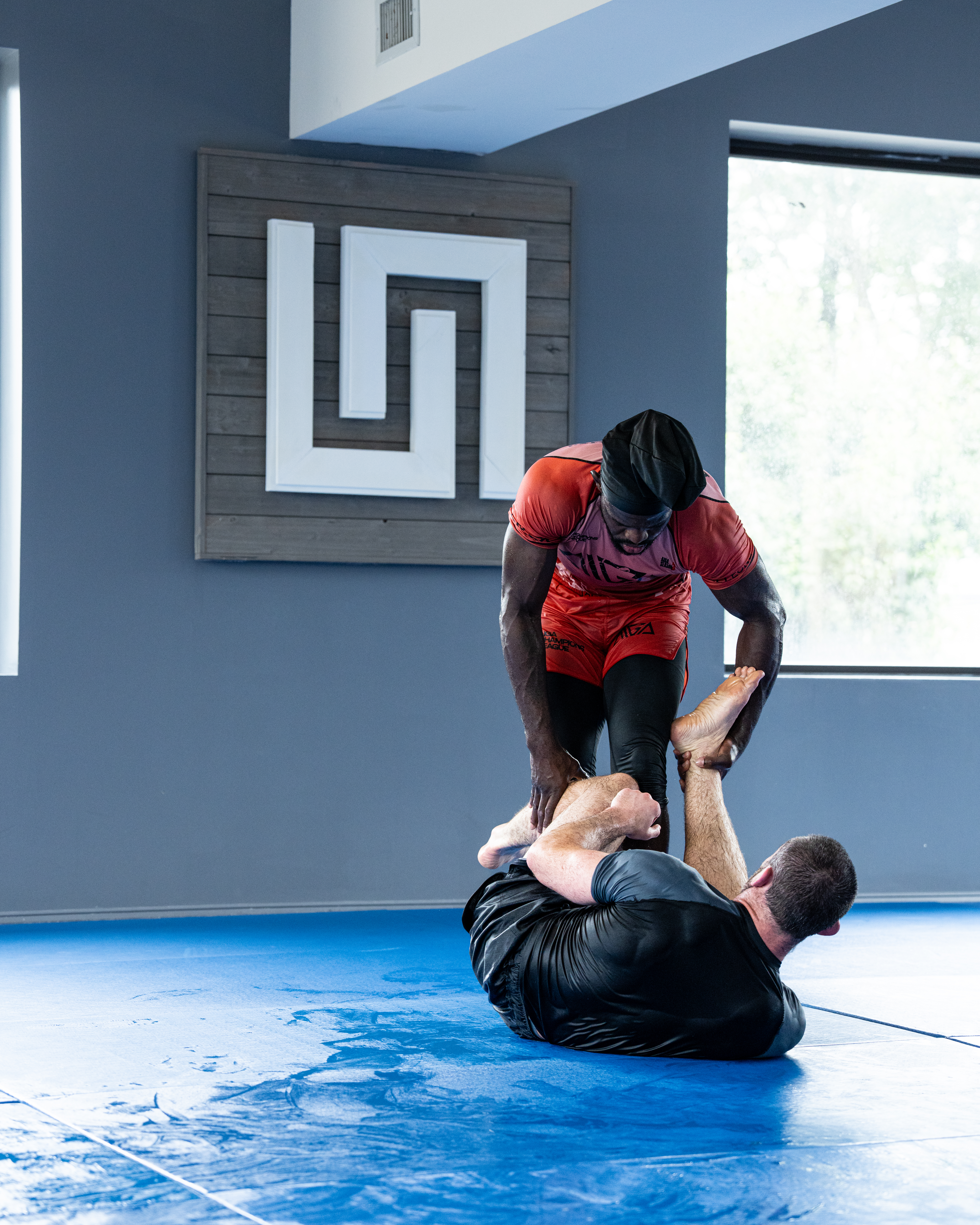 a student working with Coach Bones in nogi