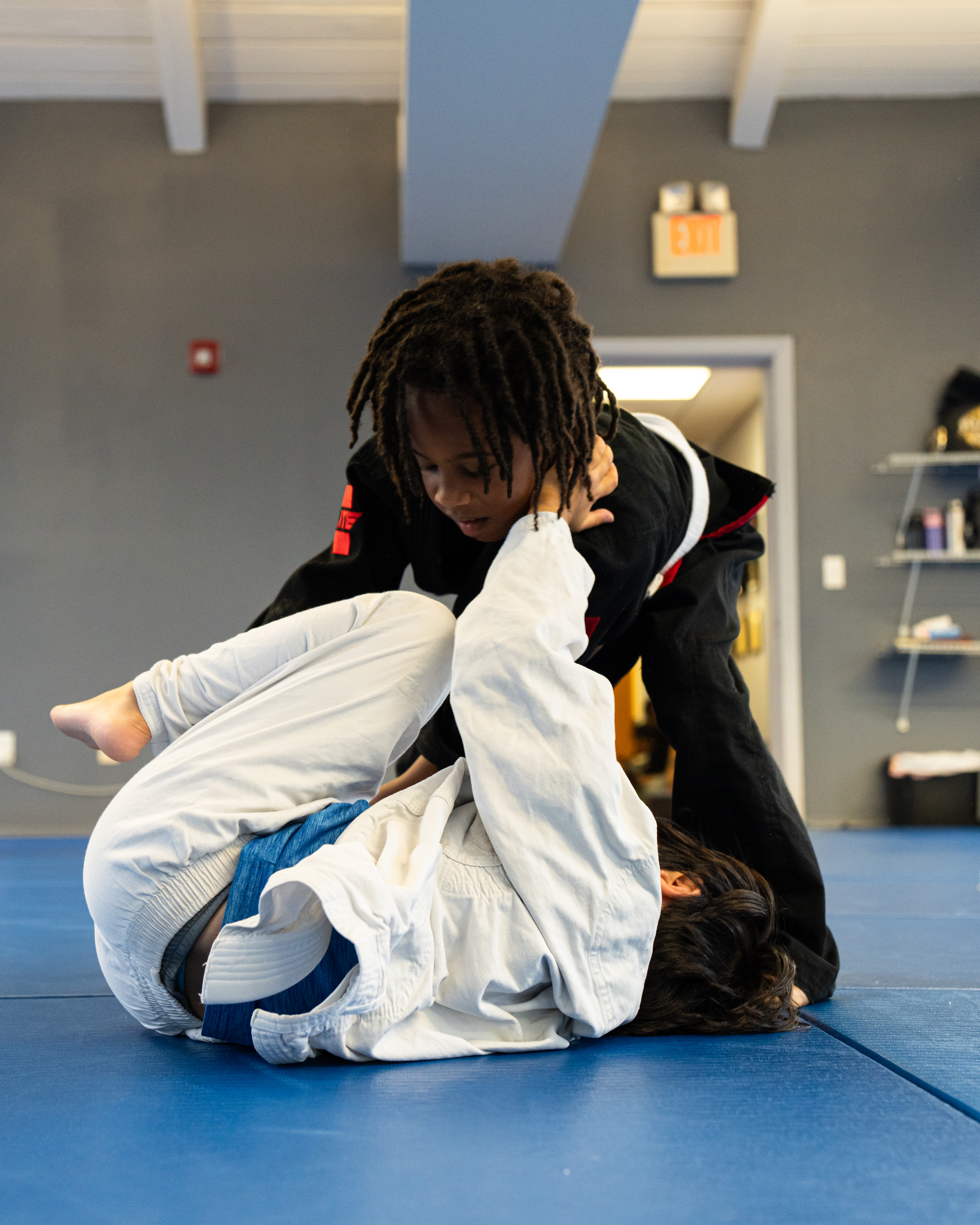 two kids training in the gi