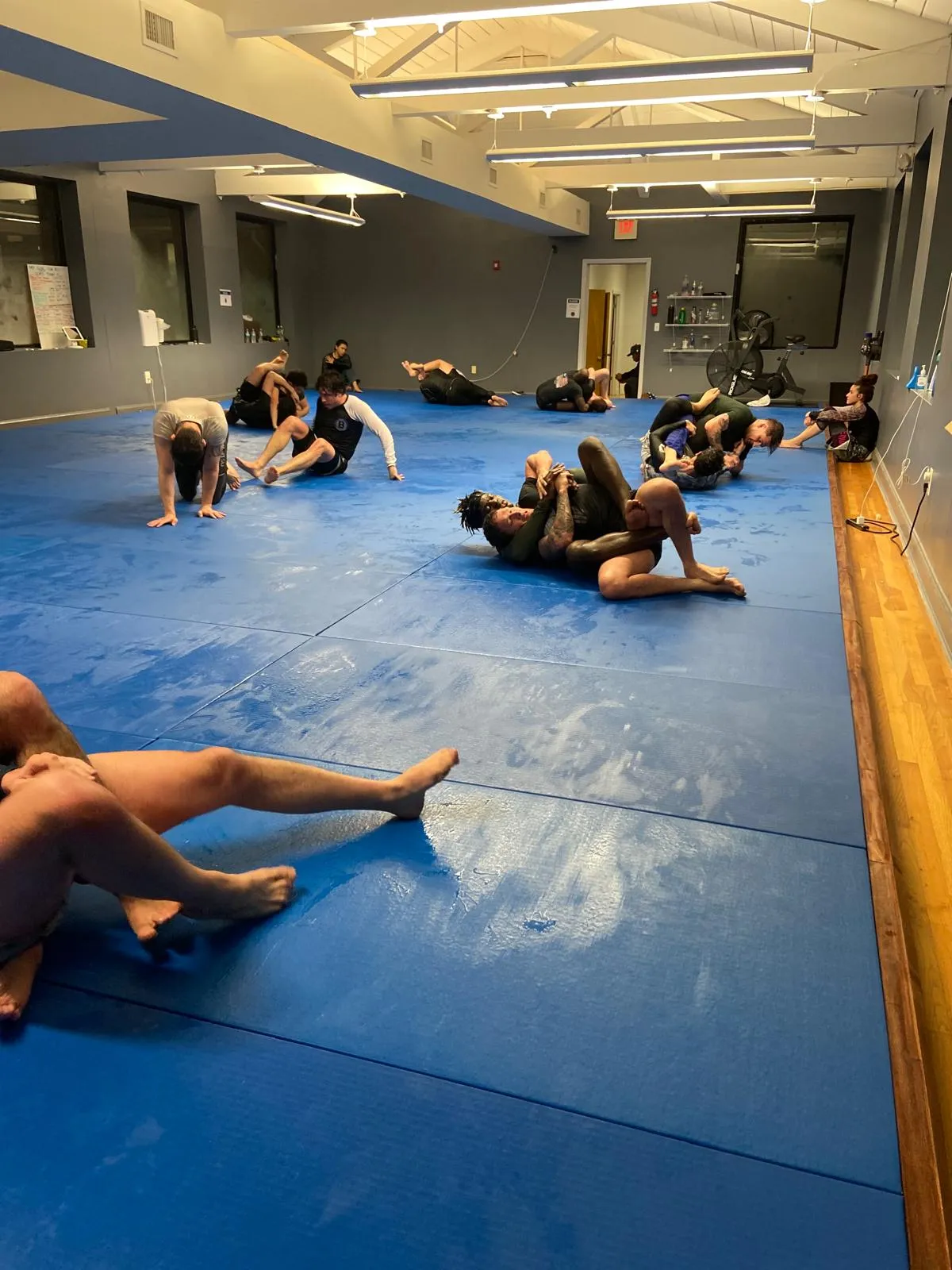 group of young adult class training jiu jitsu