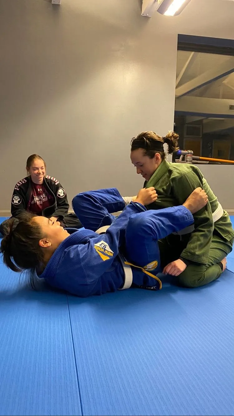Female Students training while email coach is looking on