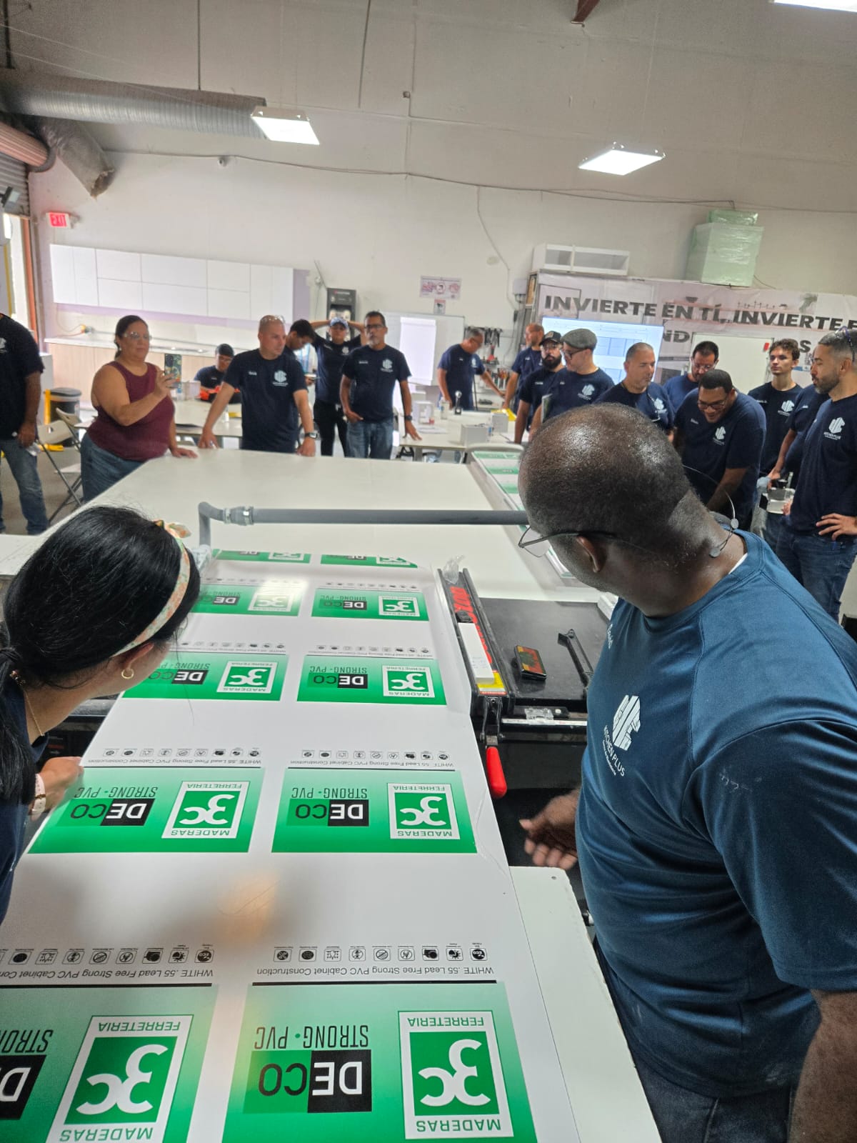 Young girl wearing apron kneading dough in kitchen.