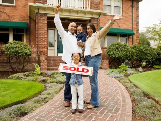 Happy family buying their first home with a mortgage broker. 