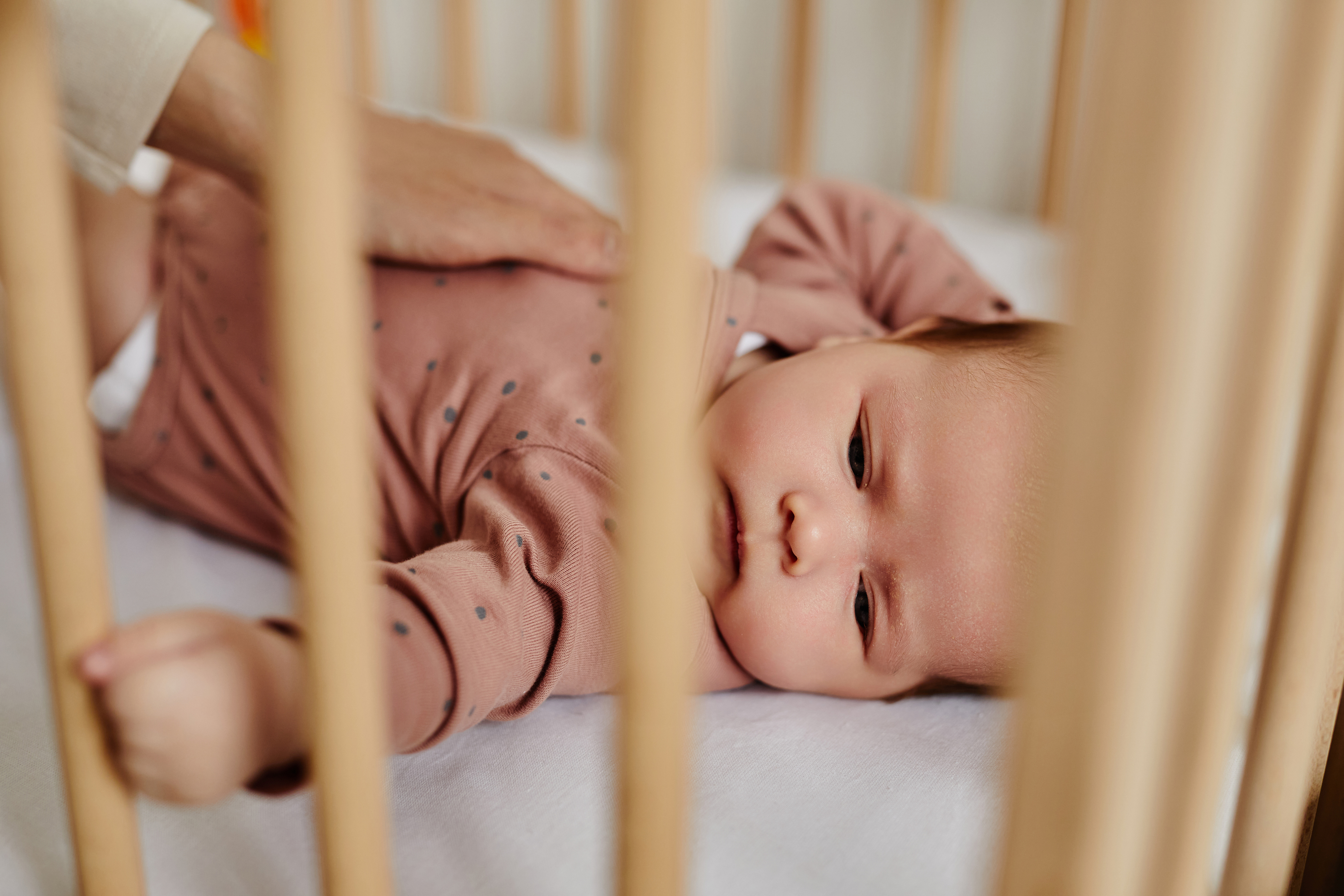 Baby awake in a cot