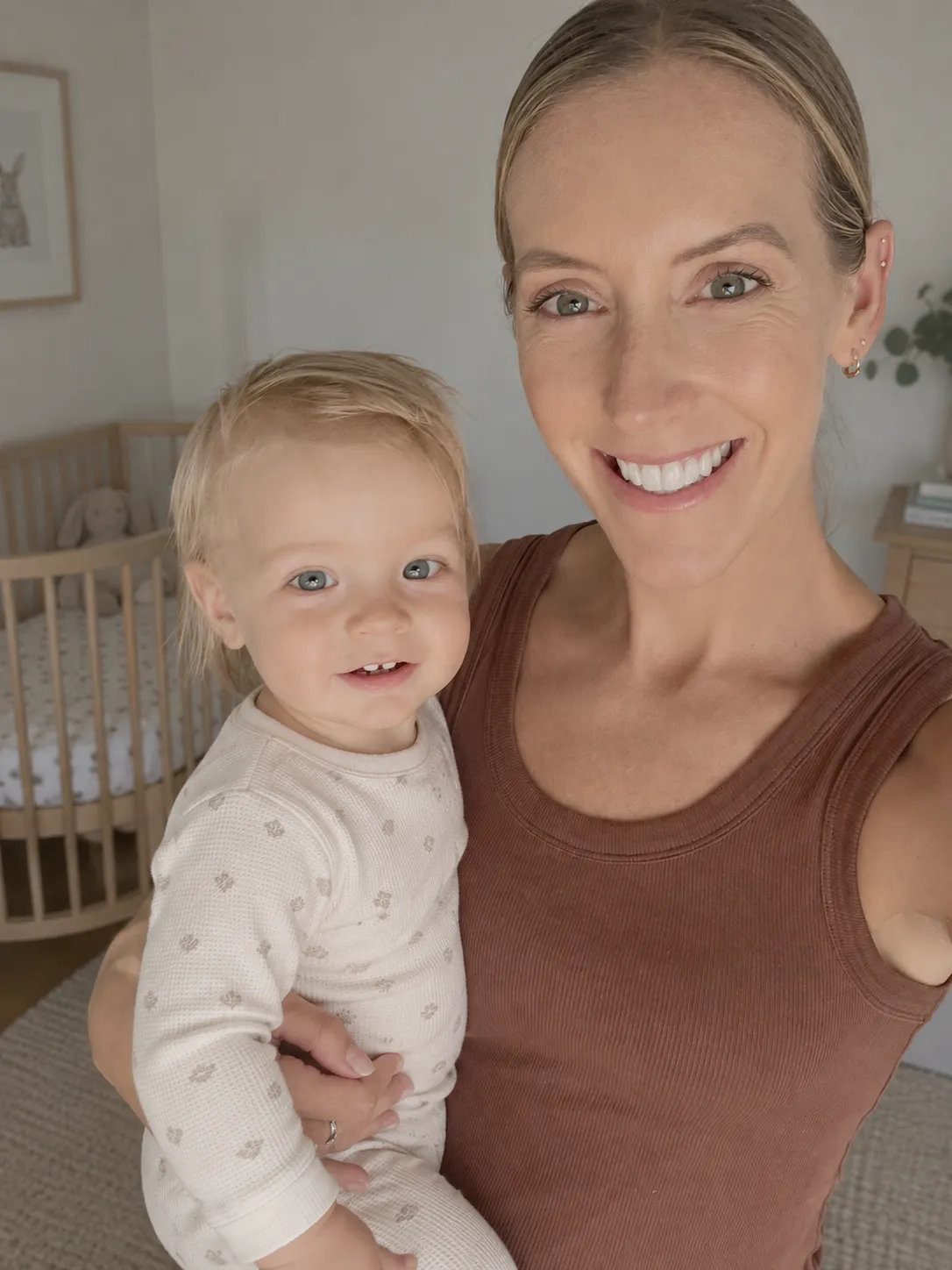Elly, Baby Sleep Collective sleep consultant, with her baby beside a cot