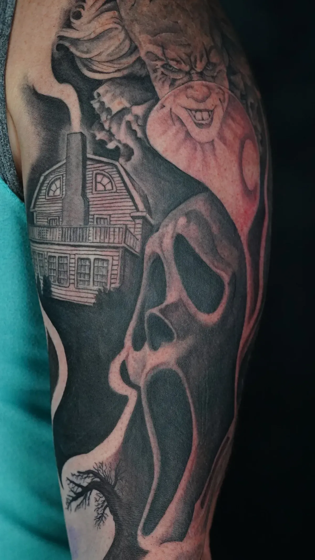 Black and Grey Realism Portrait tattoo Missoula, Montana by Mickey at Unorthodox Tattoo, showing a dramatic, deeply shaded portrait with fine tonal gradients and a haunting, cinematic quality titled Scream House for Kelsie.