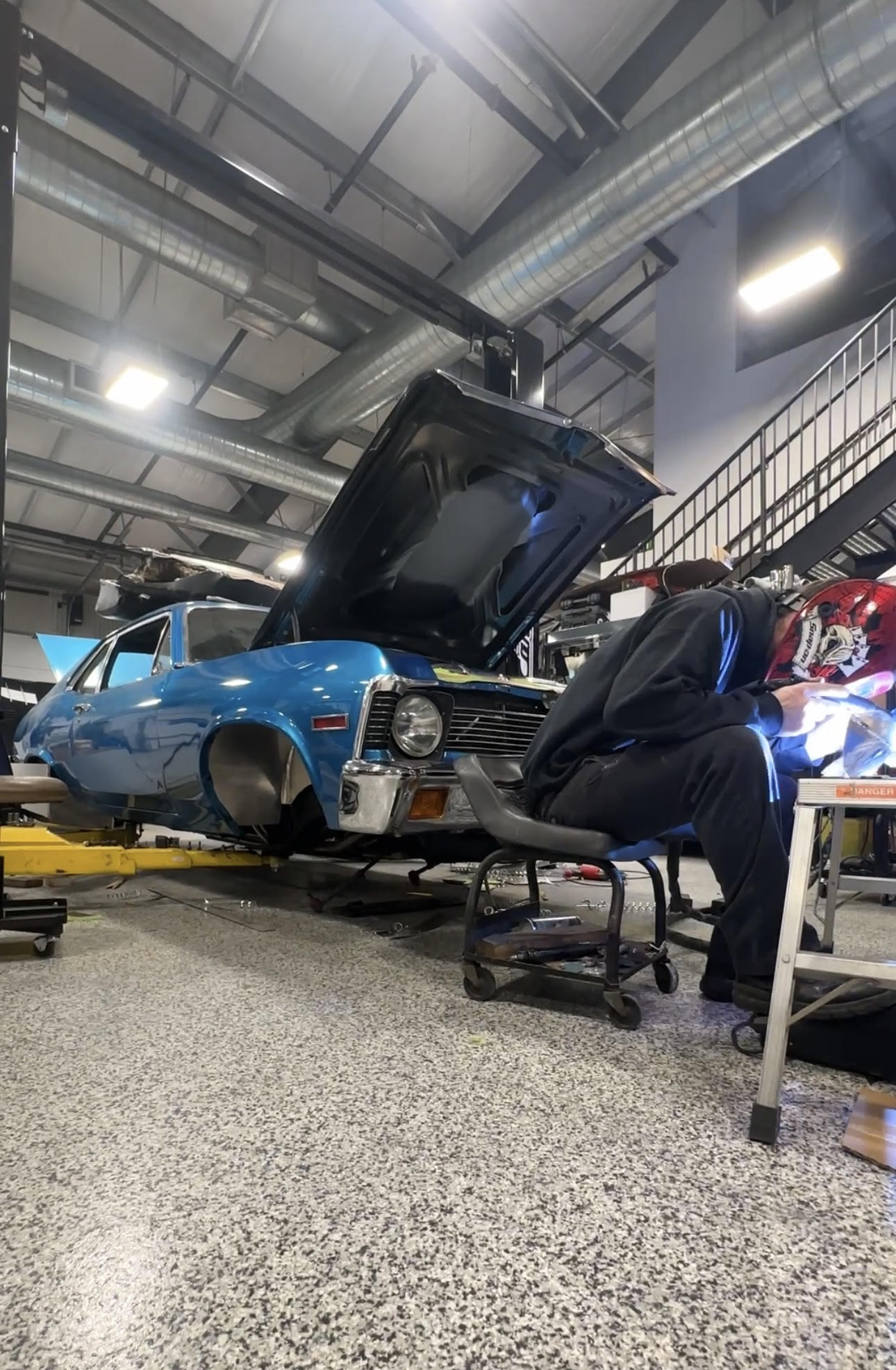 Car Toyz technician welding in front of a 1969 Chevrolet Nova