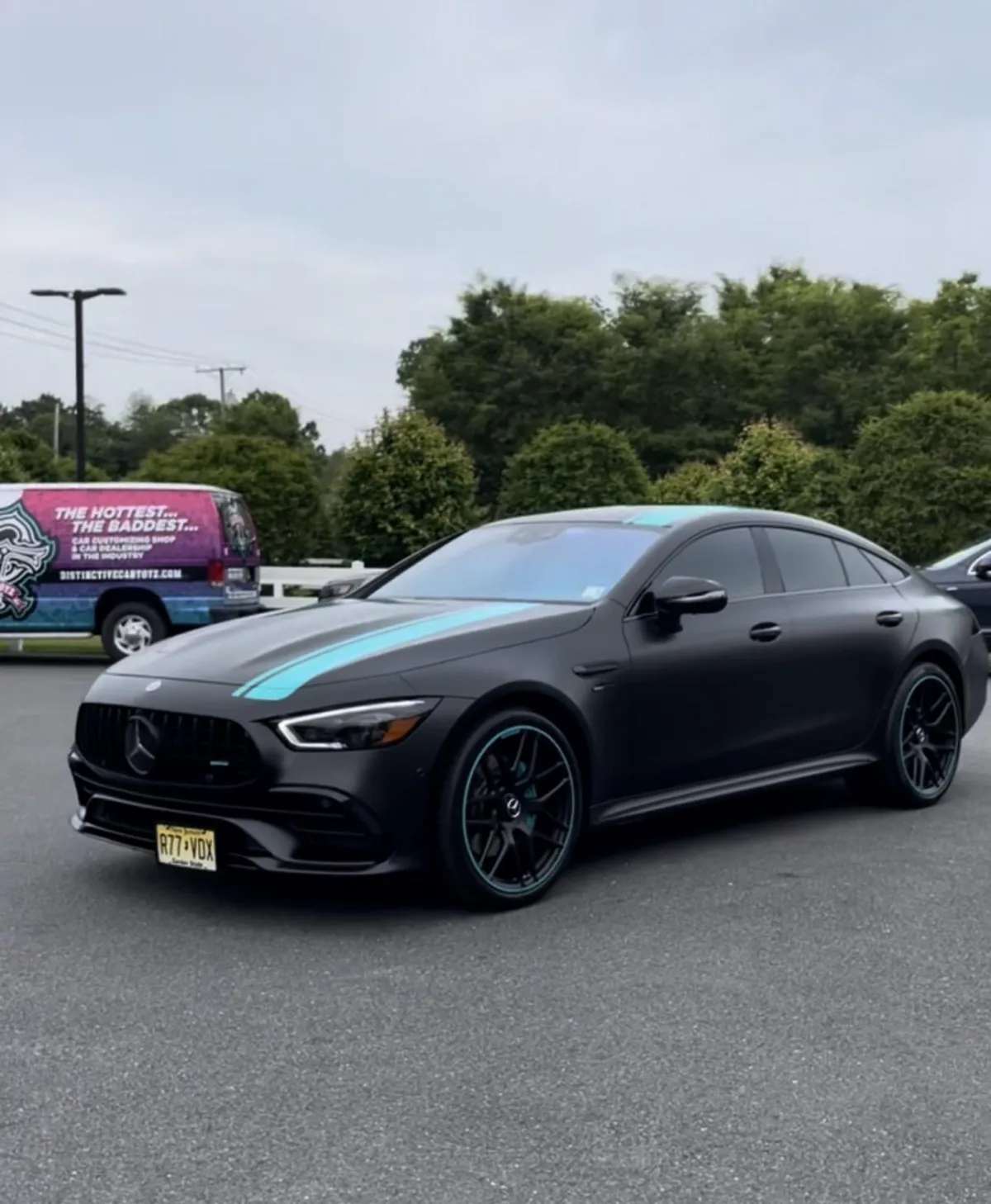 Custom black wrap with blue racing stripe applied to Mercedes-Benz at Car Toyz in Egg Harbor Township, New Jersey