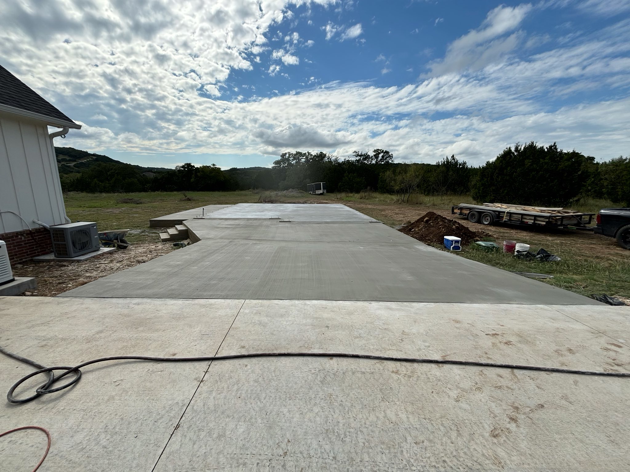 grayscale photo of bridge under cloudy sky