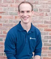 Headshot of Calvin Nause smiling in the gym