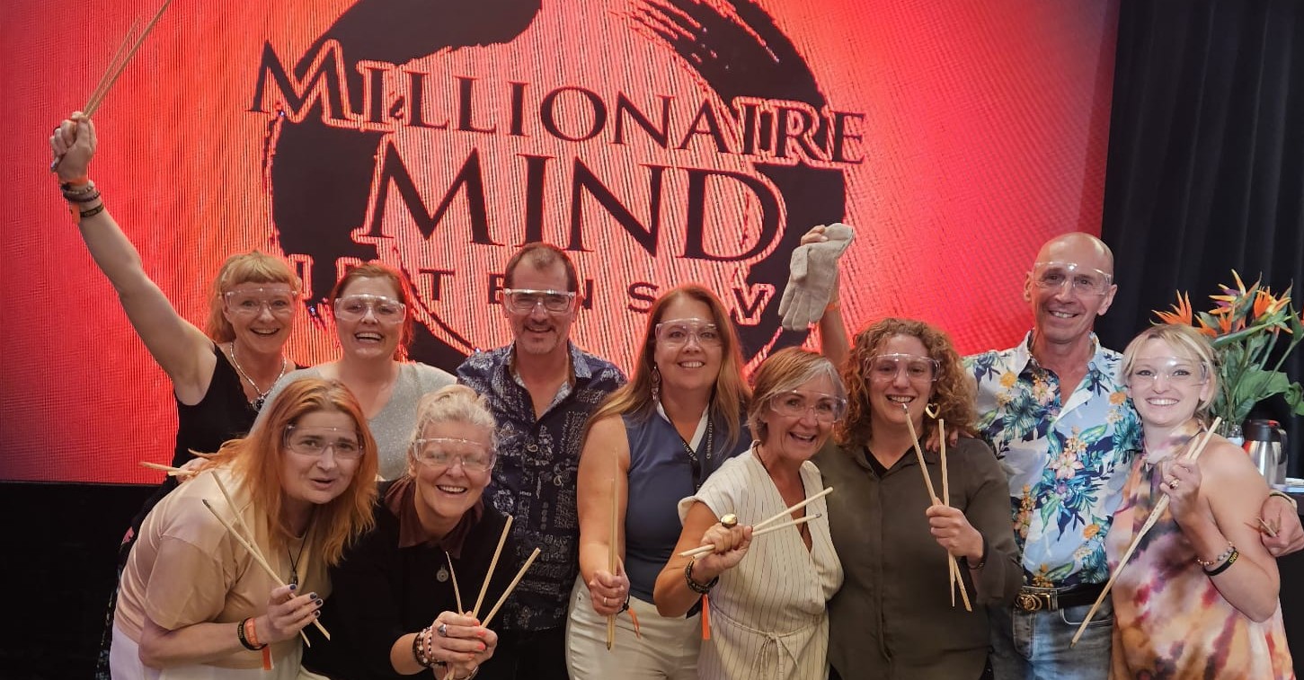 a group of people standing around a table