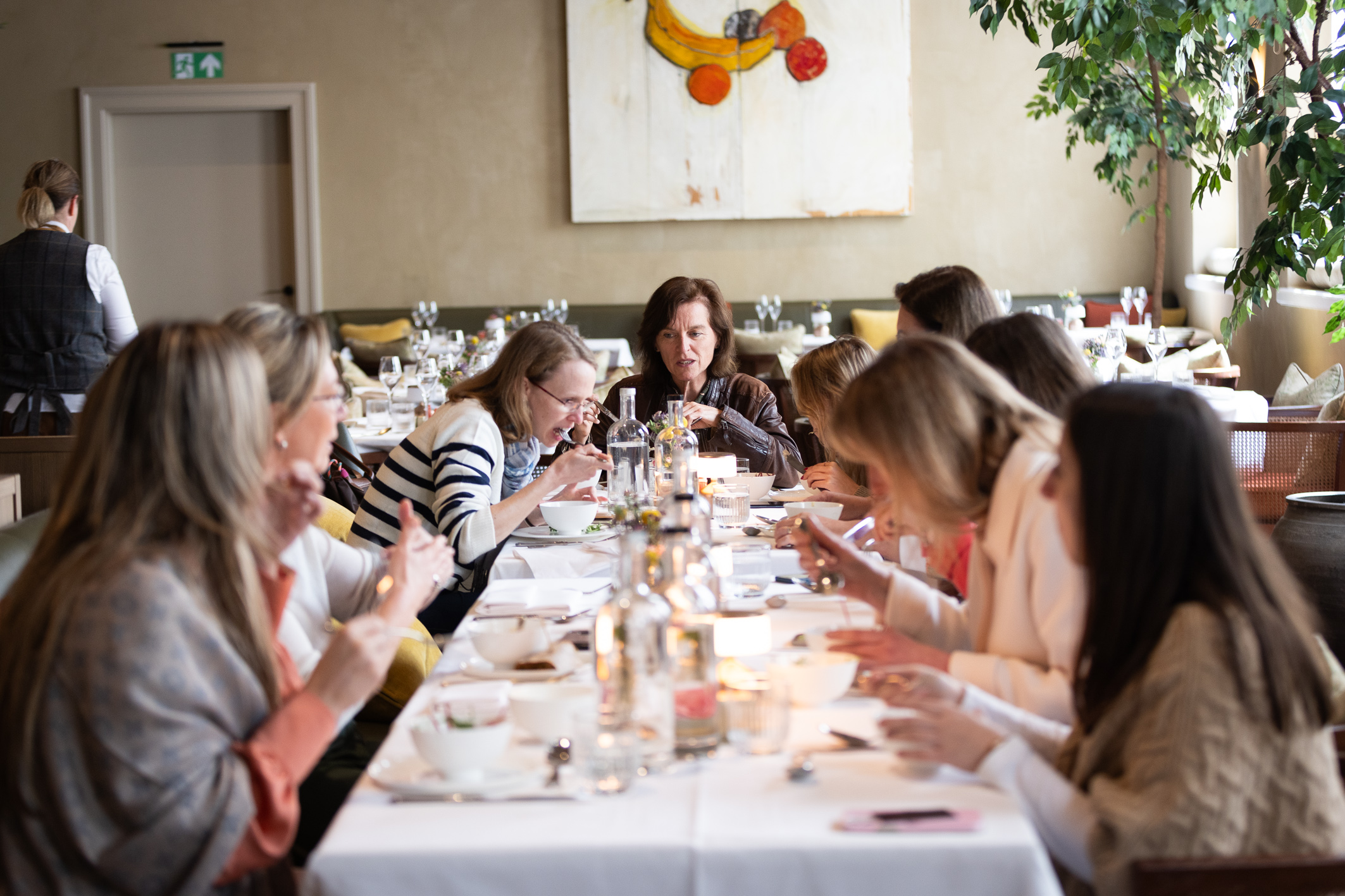 people sitting in front of table talking and eating