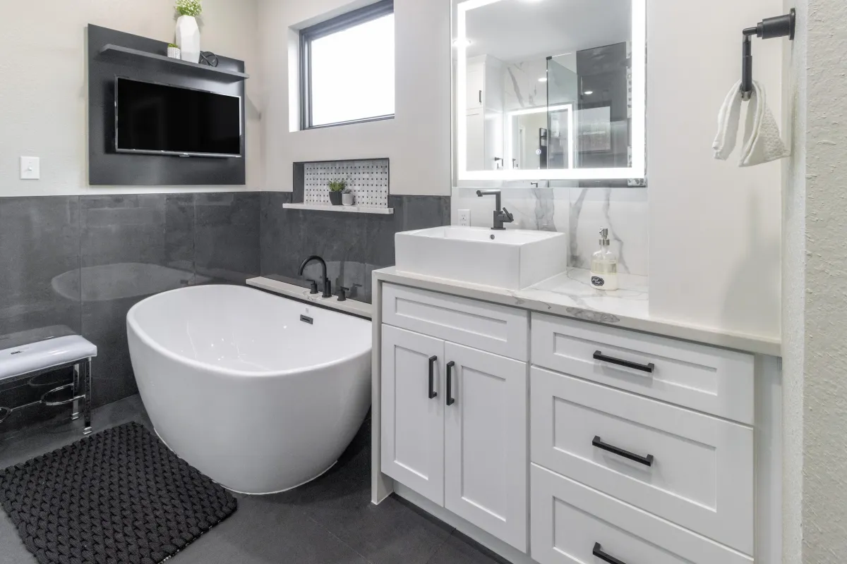 a bathroom with green cabinets and a marble shower