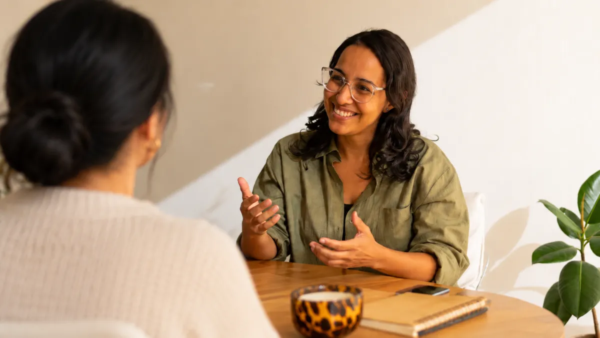 Private Coaching - Two women having a conversation, smiling