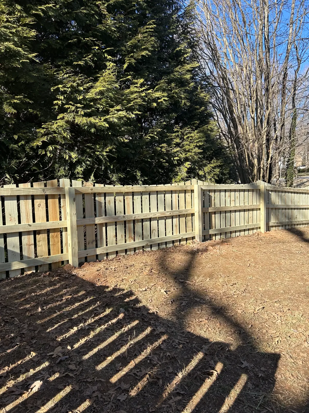 a proud fence builder putting up a fence